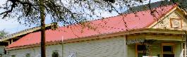 This is Muellers' CF [concealed fastner panel] in 26ga.  The color is Sunset Red and it is installed with J-Closure along the ridge and headwall on the upstairs portion which is not visible in this photo.  J-closure allows for a tight closure but requires very accurate measurements.